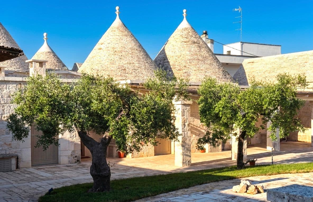 Corte dei trulli con ulivi al sole